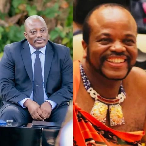 A person in a purple dress is cooking over an open fire inside a rustic kitchen with stone walls and a small window.